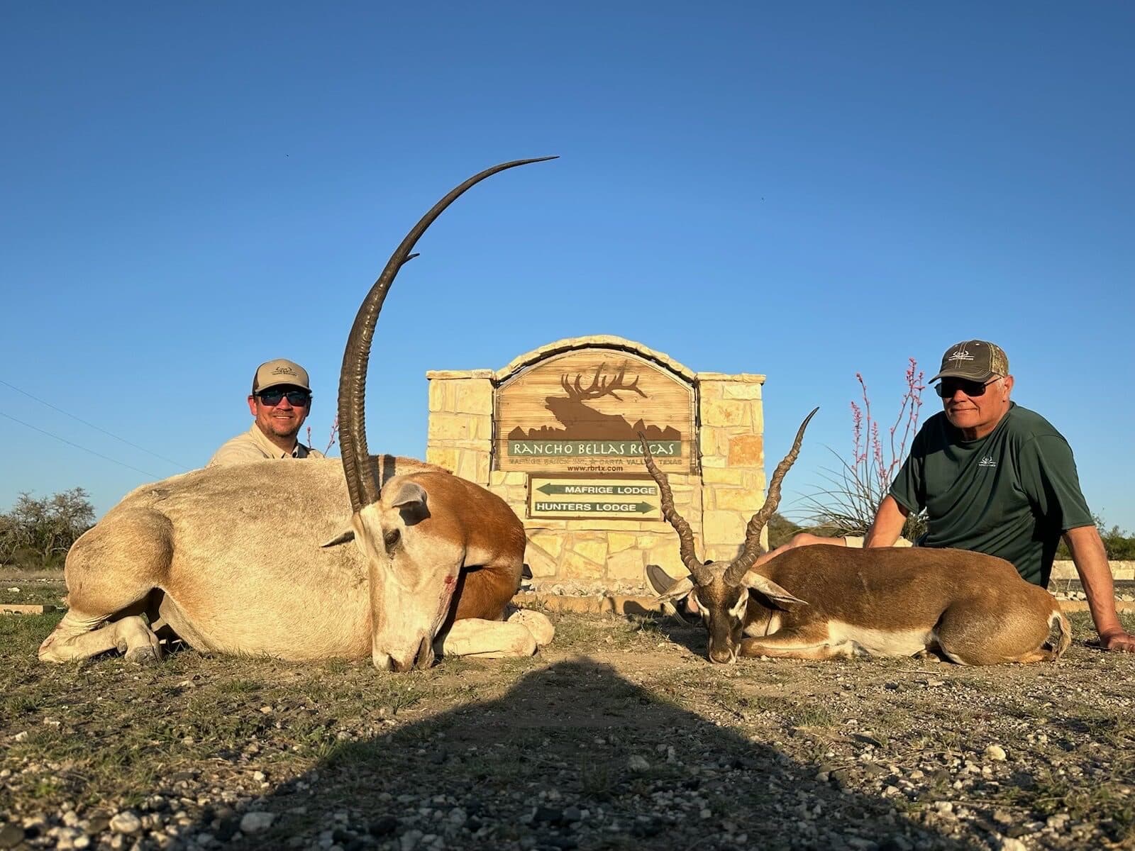 Hunters at the ranch gate after a successful hunt